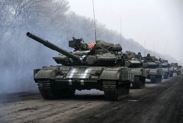 Ukrainian servicemen ride on a tank near Debaltseve, eastern Ukraine February 14, 2015. (Photo by Gleb Garanich/Reuters)