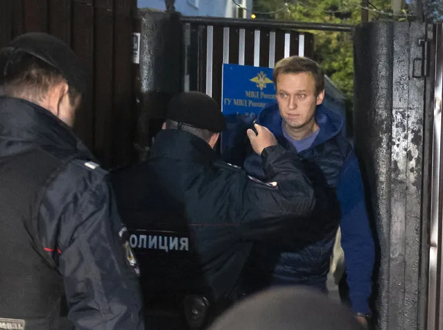 Police officers detain Russian opposition activist Alexei Navalny as he leaves a detention center after a month in jail for an unsanctioned protest rally, in Moscow, Russia, Monday, September 24, 2018. (Photo by Dmitry Serebryakov/AP Photo)