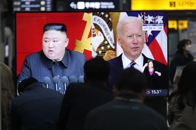 Commuters watch a TV showing a file image of North Korean leader Kim Jong Un and U.S. President Joe Biden during a news program at the Suseo Railway Station in Seoul, South Korea, Friday. March 26, 2021. North Korea on Friday confirmed it had tested a new guided missile, as Biden warned of consequences if Pyongyang escalates tensions amid stalled nuclear negotiations. (Photo by Ahn Young-joon/AP Photo)