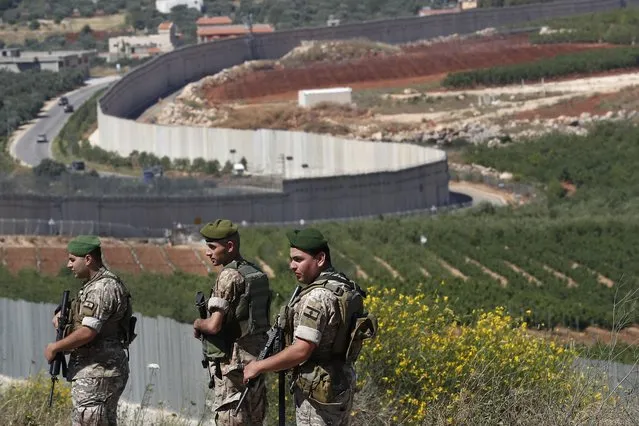 Lebanese army soldiers deploy at the Lebanese side of the Lebanese-Israeli border in the southern village of Kfar Kila, Lebanon, Saturday, May 15, 2021. (Photo by Hussein Malla/AP Photo)