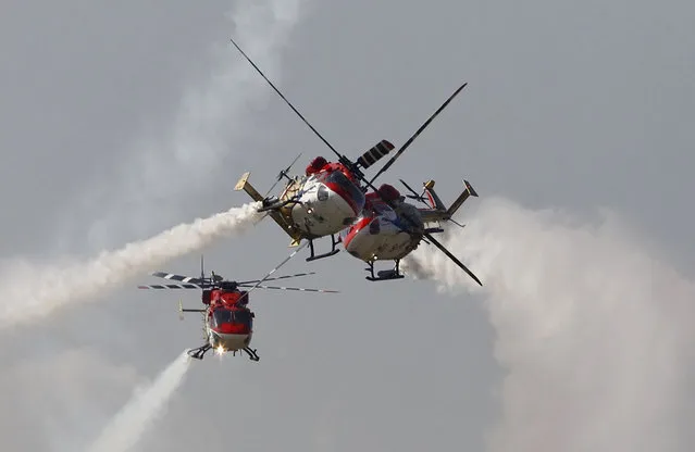 The Indian Air Force (IAF) advanced light helicopters display team “Sarang” performs during an air show organised by the IAF at the airport in Srinagar October 18, 2013. (Photo by Danish Ismail/Reuters)