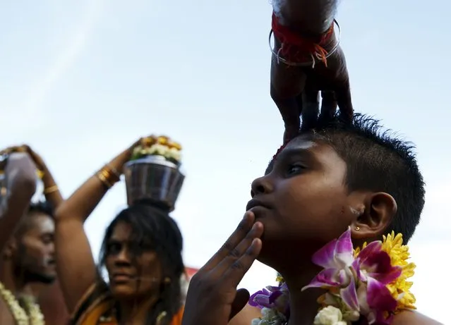 A young Hindu devotee is blessed during Thaipusam at Batu Caves in Kuala Lumpur, Malaysia, January 23, 2016. (Photo by Olivia Harris/Reuters)