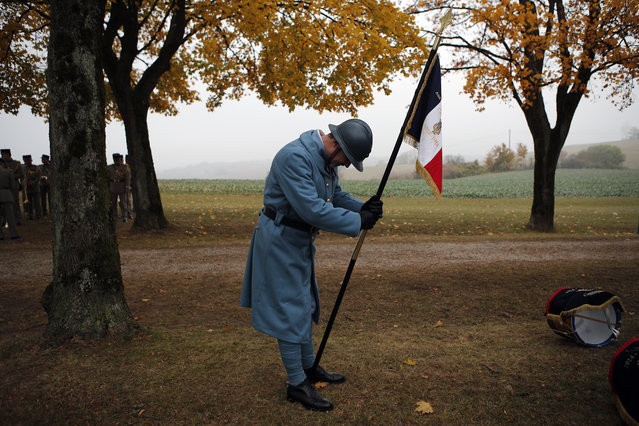 Reenactor soldier waits for the arrival of French President Emmanuel Macron during a ceremony as part of the celebrations of the centenary of the First World War, in Morhange, eastern France, Monday, November 5, 2018. French President Emmanuel Macron kicks off a week of commemorations for the 100th anniversary of the end of World War One, which is set to mix remembrance of the past and warnings about the present surge in nationalism around the globe. (Photo by Francois Mori/AP Photo)