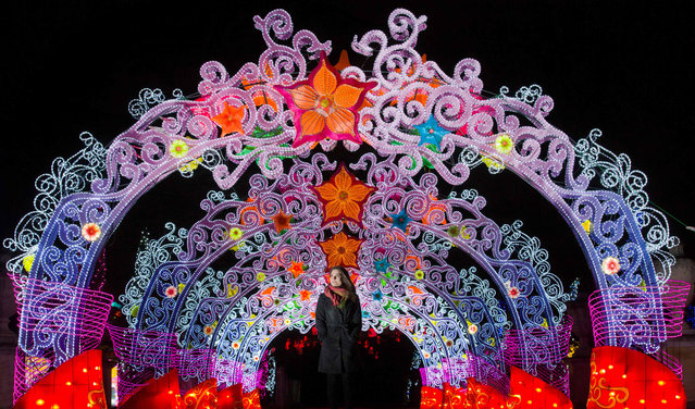 A woman poses for photograph in a tunnel of light during a photocall to promote the Magical Lantern Festival at Chiswick House Gardens in west London on January 29, 2016. (Photo by Justin Tallis/AFP Photo)