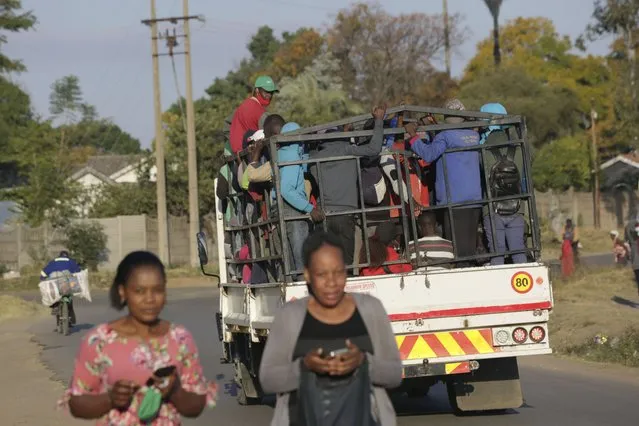 A truck loaded with people travels on a street, in Harare, Tuesday, July, 6, 2021. Zimbabwe has reactivated strict lockdown measures it once imposed when COVID-19 first hit the country last year, as the country battles a resurgence of the virus amid vaccine shortages. (Photo by Tsvangirayi Mukwazhi/AP Photo)