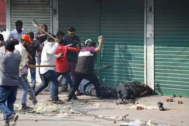 Activists of the Bangladesh Nationalist Party attack security officers during a protest in Dhaka, Bangladesh, Saturday, October 28, 2023. Police in Bangladesh's capital fired tear gas to disperse supporters of the main opposition party who threw stones at security officials during a rally demanding the resignation of Prime Minister Sheikh Hasina and the transfer of power to a non-partisan caretaker government to oversee general elections next year. (Photo by Mahmud Hossain Opu/AP Photo)