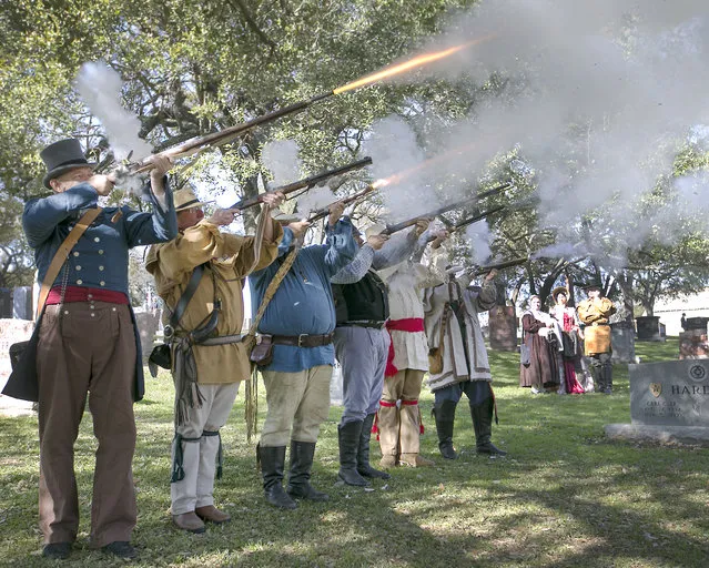 Wearing period costumes,men fire a round to commemorate those that fought and died in the Texas Revolution, Wednesday, March 2, 2016 on the grounds of the Texas State Cemetery in Austin, Texas. Today marks the 180th anniversary of Texas Independence Day, and Celebrate Texas organized a celebration to honor the dead from the Texas Revolution with speakers and a musket volley. (Photo by Ralph Barrera/Austin American-Statesman via AP Photo)