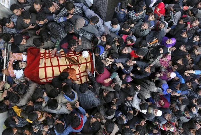 Kashmiri Muslim villagers gather around the body of Dawood Ahmad Sheikh, a suspected militant, during his funeral in Kaimuh village in south Kashmir's Kulgam district March 7, 2016. Sheikh was killed in a gunbattle with Indian security forces on Sunday evening in south Kashmir, local media reported. (Photo by Danish Ismail/Reuters)