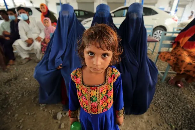 Afghans wait for their turn to renew their Proof of Registration (POR) cards at Drive (Document Renewal and Information Verification Exercise) Site Tarnab in Peshawar, Pakistan, 30 September 2021. Pakistan has updated details of more than 500,000 registered Afghan refugees as part of a country-wide campaign to issue renewed Proof of Registration (PoR) cards. Some 1.4 million already registered Afghan refugees are being verified and issued with new biometric cards through 35 sites and four mobile units. The last large-scale verification of refugees in the country was undertaken 10 years ago. (Photo by Arshad Arbab/EPA/EFE)