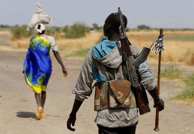 An armed man walks on a path close to the village of Nialdhiu, South Sudan February 7, 2017. (Photo by Siegfried Modola/Reuters)