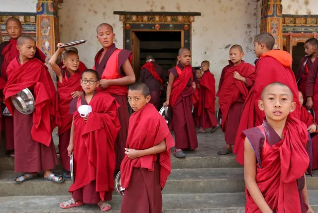 Young monks take a break from their studies at Changangkha Lhakhang temple in Thimphu, Bhutan, April 13, 2016. (Photo by Cathal McNaughton/Reuters)