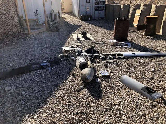 Parts of the wreckage of a drone are laid out on the ground near the Ain al-Asad airbase, in the western Anbar province of Iraq, Tuesday, January 4, 2022. Two explosives-laden drones targeting the base housing U.S. troops were engaged and destroyed by defensive capabilities at the base on Tuesday, a coalition official said. (Photo by International Coalition via AP Photo)