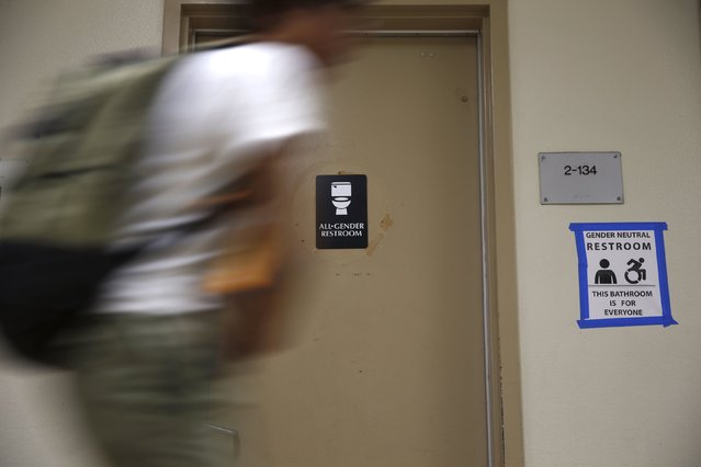 A student walks past the first gender-neutral restroom in the Los Angeles school district at Santee Education Complex high school in Los Angeles, California, U.S., April 18, 2016. (Photo by Lucy Nicholson/Reuters)