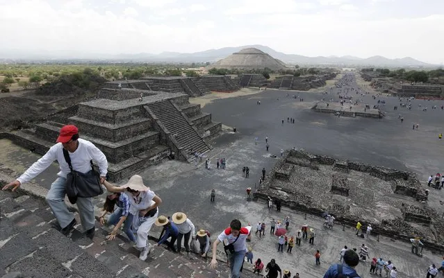 Tourists climb the Pyramid of the Moon at the Teotihuacan archaeological site on the outskirts of Mexico City, March 30, 2014. (Photo by Mariana Bazo/Reuters)
