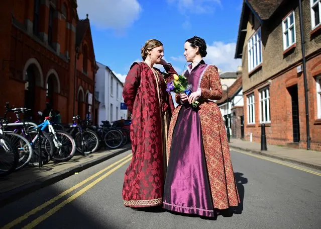 Two women in costume talk in a side-street as they prepare for the parade marking the 400 years since the death of William Shakespeare, in Stratford-upon-Avon in central England on April 23, 2016. William Shakespeare's hometown of Stratford-upon-Avon on Saturday leads the global celebrations to mark 400 years since the playwright's death, with enough star-studded plays, concerts and parades to bring the town to a standstill. (Photo by Leon Neal/AFP Photo)