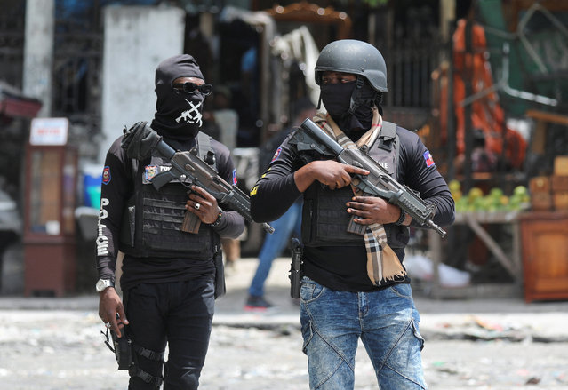 Police officers stand guard in the street, in Port-au-Prince, Haiti on May 1, 2024. (Photo by Ralph Tedy Erol/Reuters)