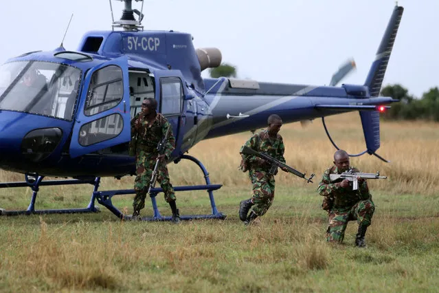 A special unit of wildlife rangers demonstrate an anti-poaching exercise ahead of the Giant Club Summit of African leaders and others on tackling poaching of elephants and rhinos, at Ol Pejeta conservancy near the town of Nanyuki, Laikipia County, Kenya, April 28, 2016. (Photo by Siegfried Modola/Reuters)