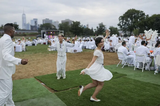 Diner En Blanc, a secret pop up dinner, is held this year on Governors Island in New York, U.S., September 17, 2018. (Photo by Stephen Yang/Reuters)