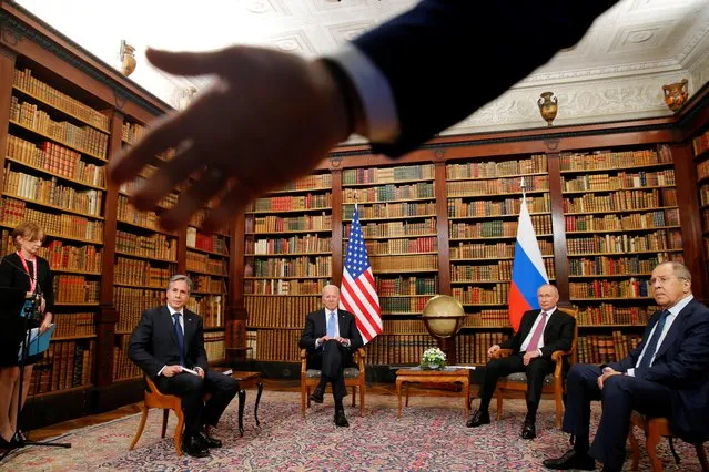 A security officer indicates to the media to step back as (From L) US Secretary of State Antony Blinken, US President Joe Biden, Russia's President Vladimir Putin and Russia's Foreign Minister Sergei Lavrov meet at the “Villa la Grange” in Geneva on June 16, 2021. (Photo by Denis Balibouse/Pool via AFP Photo)
