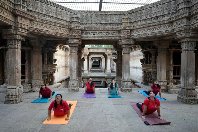 People perform Yoga to mark International Yoga Day at Adalaj Step Well in Gandhinagar, India, Friday, June 21, 2024. (Photo by Ajit Solanki/AP Photo)