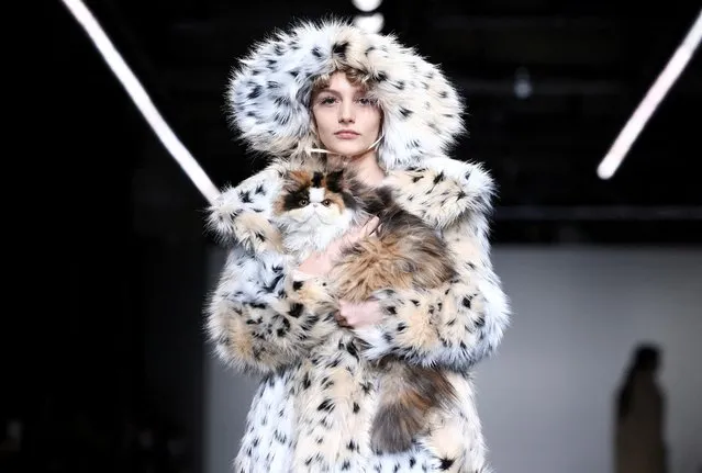 A model holds a cat during the Yuhan Wang catwalk show at London Fashion Week in London, Britain, February 20, 2022. (Photo by Henry Nicholls/Reuters)