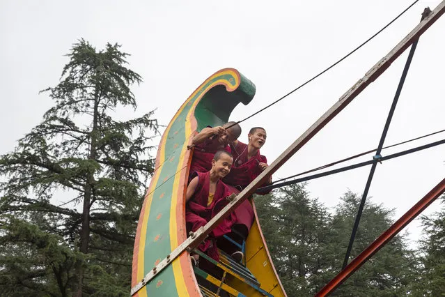 Novice Buddhist monks react as they ride a pendulum swing at a local fair in Dharmsala, India, Friday, September 6, 2019. These traditional annual fairs bring goods, food and entertainment to the residents and remain popular in small Indian towns. (Photo by Ashwini Bhatia/AP Photo)