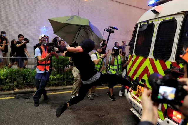 A protester kicks a police vehicle at a demonstration at Taikoo station in Hong Kong, China on October 3, 2019. (Photo by Jorge Silva/Reuters)