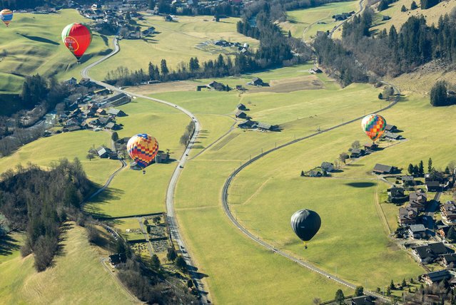 Located in an Alpine valley, the town is renowned for winds that make for particularly good flying during the 44th International Hot Air Balloon Festival in Chateau-d'Oex, Switzerland, on January 25, 2024. (Photo by Denis Balibouse/Reuters)