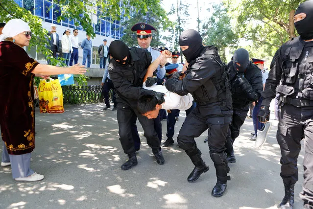 Riot police officers detain a demonstrator during a protest against President Nursultan Nazarbayev's government and an unpopular land reform it has proposed, in Almaty, Kazakhstan, May 21, 2016. (Photo by Shamil Zhumatov/Reuters)