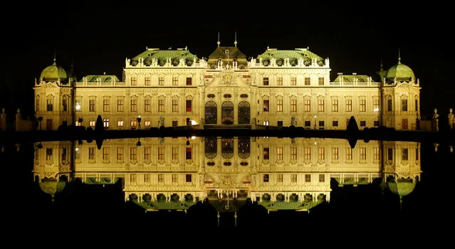 Belvedere palace and its reflection in a pond are seen before the lights were switched off for Earth Hour in Vienna, Austria, March 25, 2017. (Photo by Heinz-Peter Bader/Reuters)