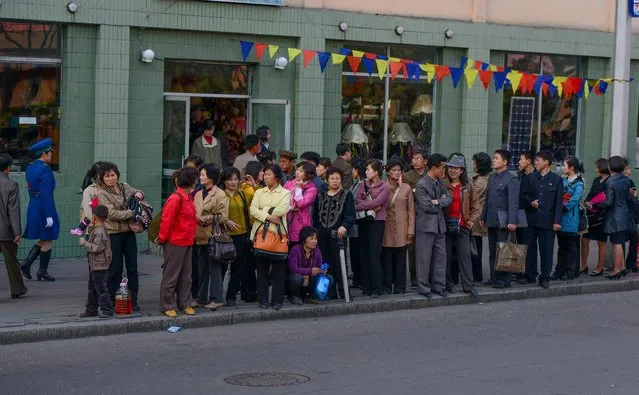 Pyongyang citizens queue for a bus in the core of the city. Public transit is essential in a country where most can’t afford cars. (Photo by Gavin John/Mediadrumworld.com)