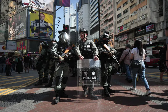 Police officers in riot gear stand guard before an anti-government protest in Hong Kong, Saturday, November 2, 2019. As Hong Kong continues on with its fifth month of anti-government protests, China vowed Friday to prevent foreign powers from interfering in Hong Kong's affairs and carrying out acts of “separatism, subversion, infiltration and sabotage”. (Photo by Dita Alangkara/AP Photo)