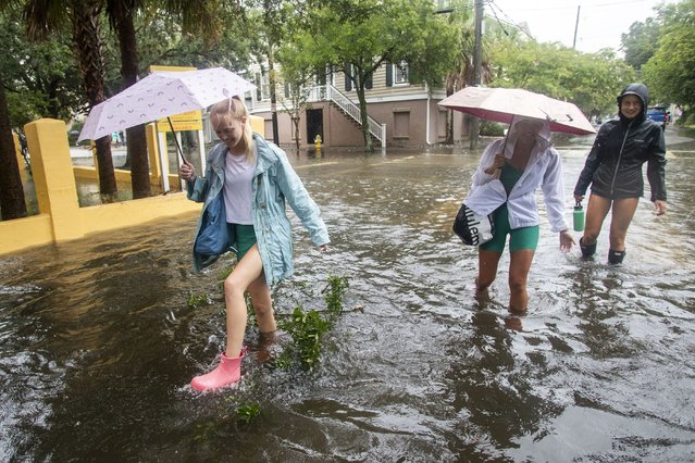 Pedestrians make their way down Montagu St. in Charleston, S.C., as Tropical Storm Debby approaches, Tuesday, August 6, 2024. (Photo by Mic Smith/AP Photo)