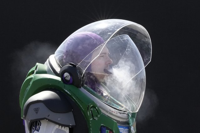 A man in a Buzz Lightyear costume smokes as he arrives to attend the MCM Comic Con at Excel in London, Friday, May 26, 2023. The event is a three-day celebration of all things pop culture. (Photo by Kirsty Wigglesworth/AP Photo)