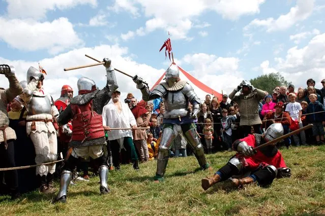 People fight during the reenactment of a tournament of knights fight, in Agincourt, northern France, Saturday, July 25, 2015. (Photo by Thibault Camus/AP Photo)