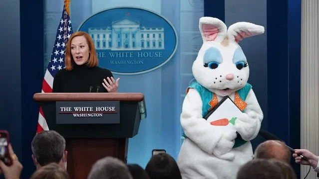 An Easter Bunny stands next to White House Press Secretary Jen Psaki as she delivers daily briefing in the Brady Briefing Room of the White House in Washington, DC on April 18, 2022. (Photo by Mandel Ngan/AFP Photo)