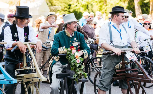 Participants dressed in historical clothing ride high-wheel bicycles during a bicycle ballet event at Schloss Karlsruhe palace during the 2017 International Veteran Cycle Association (IVCA) rally to celebrate the 200th anniversary of the bicycle on May 27, 2017 in Karlsruhe, Germany. (Photo by Alexander Scheuber/Getty Images)