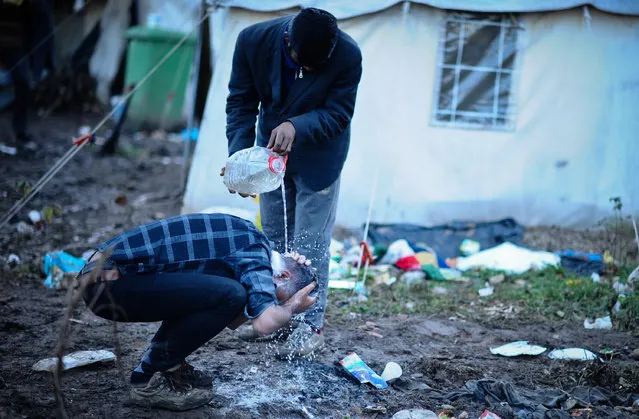 A man is seen washing his head at the camp “Vucjak” near Bihac, where irregular migrants, who were not allowed to cross the Croatian border live in, on December 07, 2019 in Bosnia and Herzegovina. Irregular migrants wait Croatia to open the border gate. About 500 irregular migrants, living in makeshift tents, wait the border gate to be opened in the freezing cold at the camp. Hundreds of irregular migrants are stranded at Bosnia and Herzegovina's border with Croatia. Only 15 kilometers from the Croatian border, irregular migrants are living in subhuman conditions in a makeshift camp, with only the dream of reaching the prosperous western European countries keeping them alive. (Photo by Mustafa Ozturk/Anadolu Agency via Getty Images)