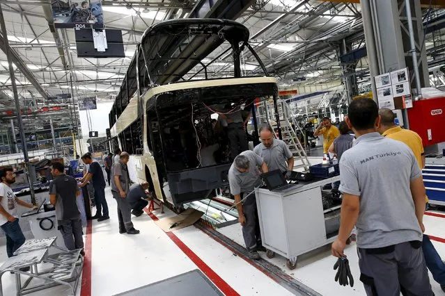 Employees work at the assembly line of the MAN Bus Production Center in Ankara, Turkey, July 29, 2015. (Photo by Umit Bektas/Reuters)
