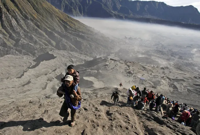 Worshippers climb Mount Bromo to throw offerings into its crater during Yadnya Kasada festival in Probolinggo, East Java, Indonesia, Saturday, August 1, 2015. (Photo by AP Photo/Trisnadi)