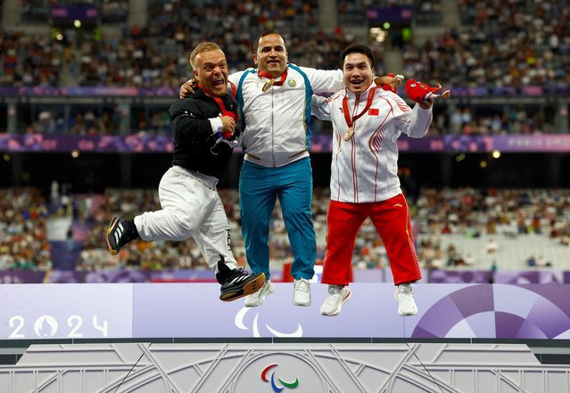 Gold medalist Bobirjon Omonov of Uzbekistan, silver medalist Niko Kappel and bronze medalist Jun Huang celebrate on the podium during the victory ceremony for F41 men's shot put on September 2, 2024. (Photo by Thomas Mukoya/Reuters)