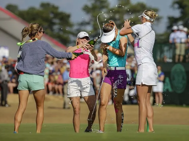 Michelle Wie is doused by friends after winning the U.S. Women's Open golf tournament in Pinehurst, N.C., on June 22, 2014. (Photo by Chuck Burton/Associated Press)