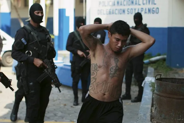 One of 13 suspected members of the 18th street gang is presented to the media after being arrested by the police under the charges of homicide and terrorism, in Soyapango, El Salvador March 31, 2016. (Photo by Jose Cabezas/Reuters)