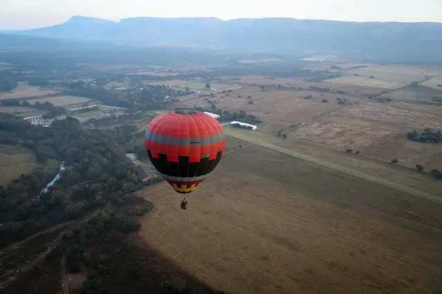 Semakaleng Mathebula, South Africa's first Black female hot-air balloon pilot, pilots a hot-air balloon over Johannesburg, South Africa on May 15, 2022. (Photo by Sumaya Hisham/Reuters)