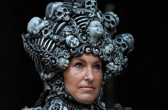 A participant in costume poses for a photograph during the biannual “Whitby Goth Weekend” festival in Whitby, northern England, on October 31, 2021. The festival brings together thousands of goths and alternative lifestyle fans from the UK and around the world for a weekend of music, dancing and shopping. (Photo by Oli Scarff/AFP Photo)