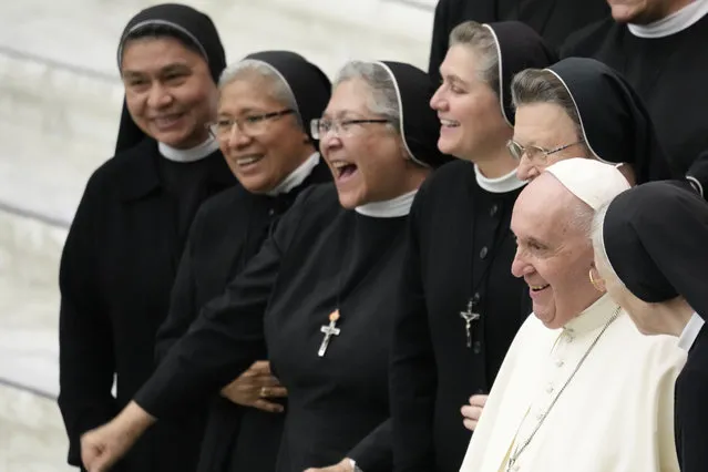 Pope Francis poses for as photo with a group of nuns at the end of his weekly general audience in the Paul VI Hall the Vatican, Wednesday, November 24, 2021. (Phoot by Andrew Medichini/AP Photo)