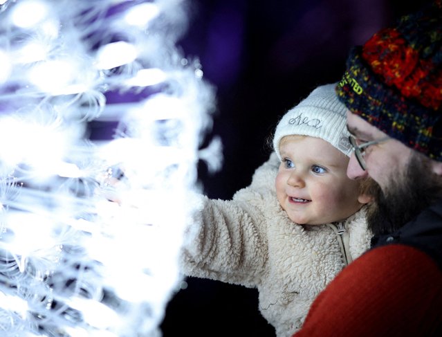 A baby views an installation at the preview ahead of the Enchanted Forest 2024 event, an annual sound and light show, at Faskally Wood Pitlochry, Scotland, Britain on October 2, 2024. (Photo by Russell Cheyne/Reuters)