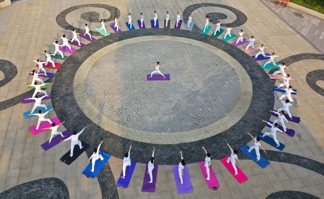 This aerial photo shows people practising yoga at a park in Handan in China's northern Hebei province on June 20, 2022, ahead of International Yoga Day on June 21. (Photo by AFP Photo/China Stringer Network)