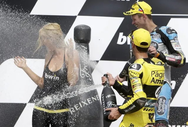 Second placed Kalex Moto2 Tito Rabat (rear R) of Spain and third placed Kalex Moto2 Alex Rins of Spain spray with champagne during the award ceremony for the Czech Grand Prix in Brno, Czech Republic, August 16, 2015. (Photo by David W. Cerny/Reuters)