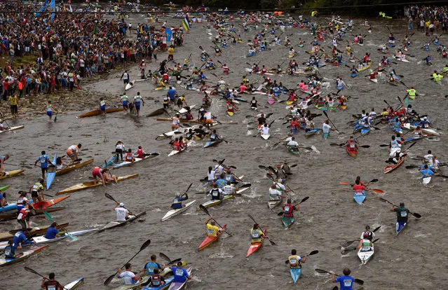 Canoeists start the annual International Descent of the River Sella event, in which participants from all over the world race along a 20km stretch of the river that starts in Arriondas and ends in the seaside resort of Ribadesella, north of Spain, August 5, 2017. (Photo by Eloy Alonso/Reuters)